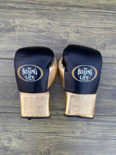 No Boxing No Life custom professional lace-up boxing gloves in black leather with metallic gold cuffs and palms.