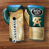 No Boxing No Life professional lace-up boxing gloves in deep green leather with a metallic gold thumb, palm, and cuff area featuring the official brand patches and gold Canelo Alvarez CA logos.
