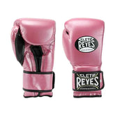 Official Cleto Reyes professional hook-and-loop training boxing gloves in pink metallic leather featuring a high-sheen magenta finish, black inner thumb lining, and traditional brand patches.