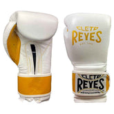 Official Cleto Reyes professional hook-and-loop training boxing gloves in white leather featuring a metallic gold printed brand logo, gold inner thumb panel, and a matching gold leather wrist strap surface.