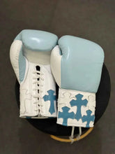 Custom Winning professional lace-up boxing gloves in sky blue and white leather featuring multiple layered sky blue leather cross patches stitched onto the white cuffs.