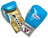 Custom Winning professional lace-up boxing gloves featuring a sky blue leather face, a metallic gold palm, a metallic silver thumb and cuff block, official brand patches, and white laces.