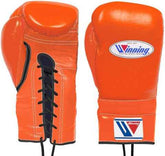Custom vibrant orange Winning MS-600 professional 16oz lace-up boxing gloves handcrafted in Japan with black laces and official branding.