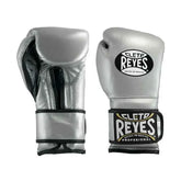 Official Cleto Reyes professional hook-and-loop training boxing gloves in silver metallic leather featuring a high-sheen chrome finish, black inner thumb lining, and traditional brand patches.