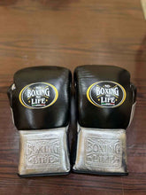 No Boxing No Life professional lace-up boxing gloves in black leather featuring brilliant metallic silver leather cuffs with deep debossed branding and the official crown logos.