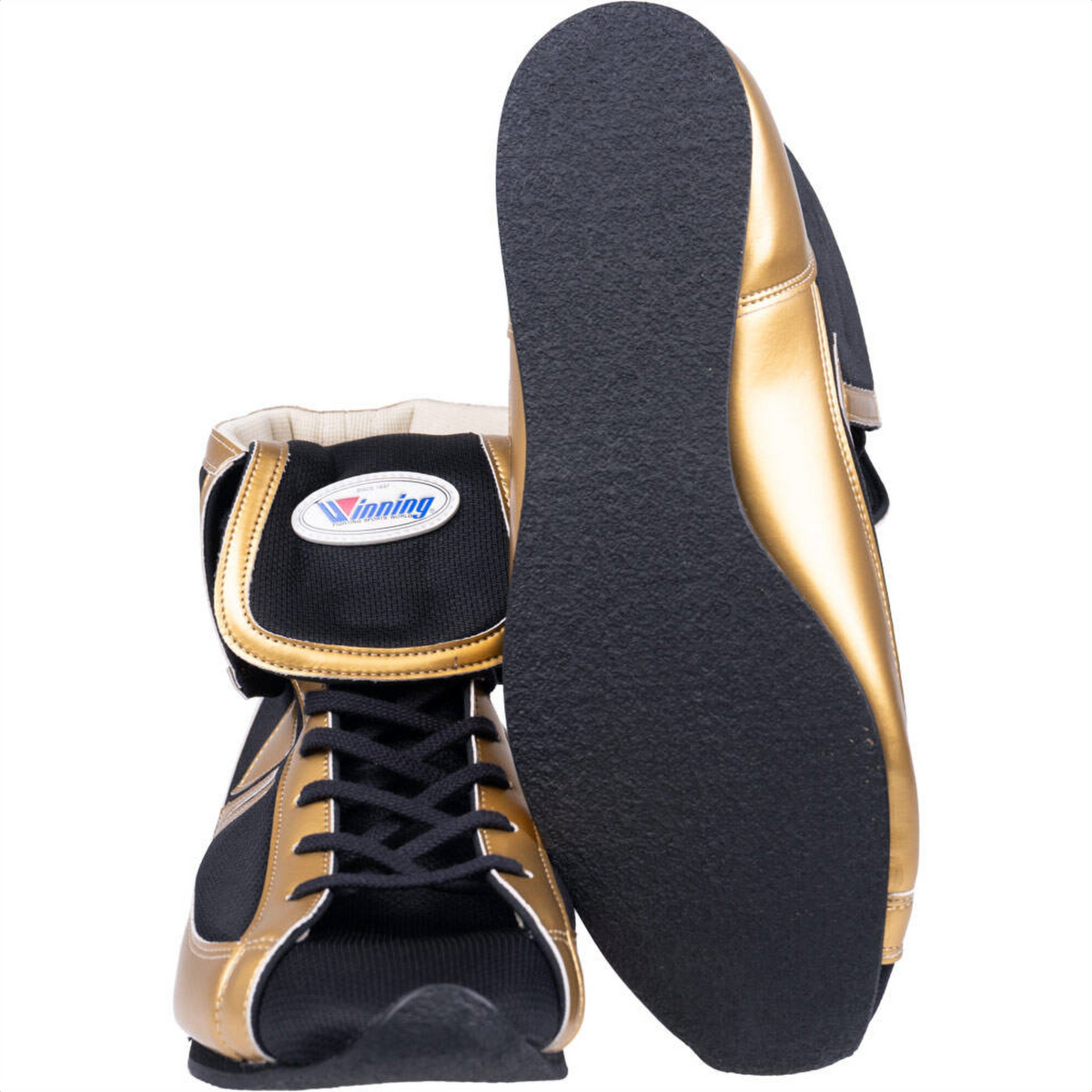 Winning short-cut boxing shoes in black and metallic gold showing side profile and textured black outsole