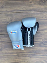 Custom metallic silver and black Winning MS-600 professional lace-up boxing gloves handcrafted in Japan with official branding.
