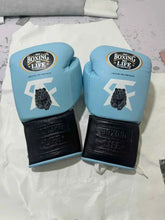 Custom No Boxing No Life professional lace-up boxing gloves in sky blue leather featuring white signature graphics, a detailed black grizzly bear emblem, and contrasting black leather cuffs.