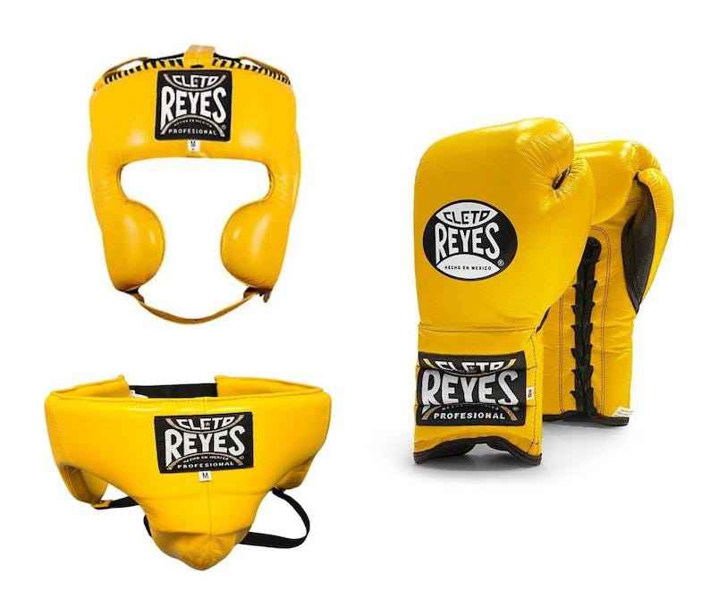 Official Cleto Reyes professional 3-piece boxing sparring gear set featuring matching lace-up gloves, a cheek protector headguard, and a groinguard in uniform vibrant yellow leather.