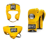 Official Cleto Reyes professional 3-piece boxing sparring gear set featuring matching lace-up gloves, a cheek protector headguard, and a groinguard in uniform vibrant yellow leather.