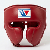 A red leather boxing headguard with a white, blue, and red Winning brand patch on the forehead, photographed against a clean white background.