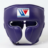 A purple leather boxing headguard with a white, blue, and red Winning brand logo patch on the forehead, shown against a plain white background.