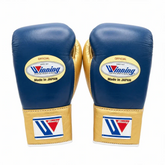 Authentic navy blue and metallic gold Winning professional boxing gloves handcrafted in Japan with official branding.
