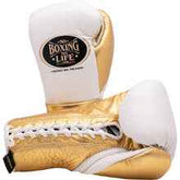 No Boxing No Life professional lace-up boxing gloves in white leather with a metallic gold palm, thumb, and cuff area featuring the official brand patch.