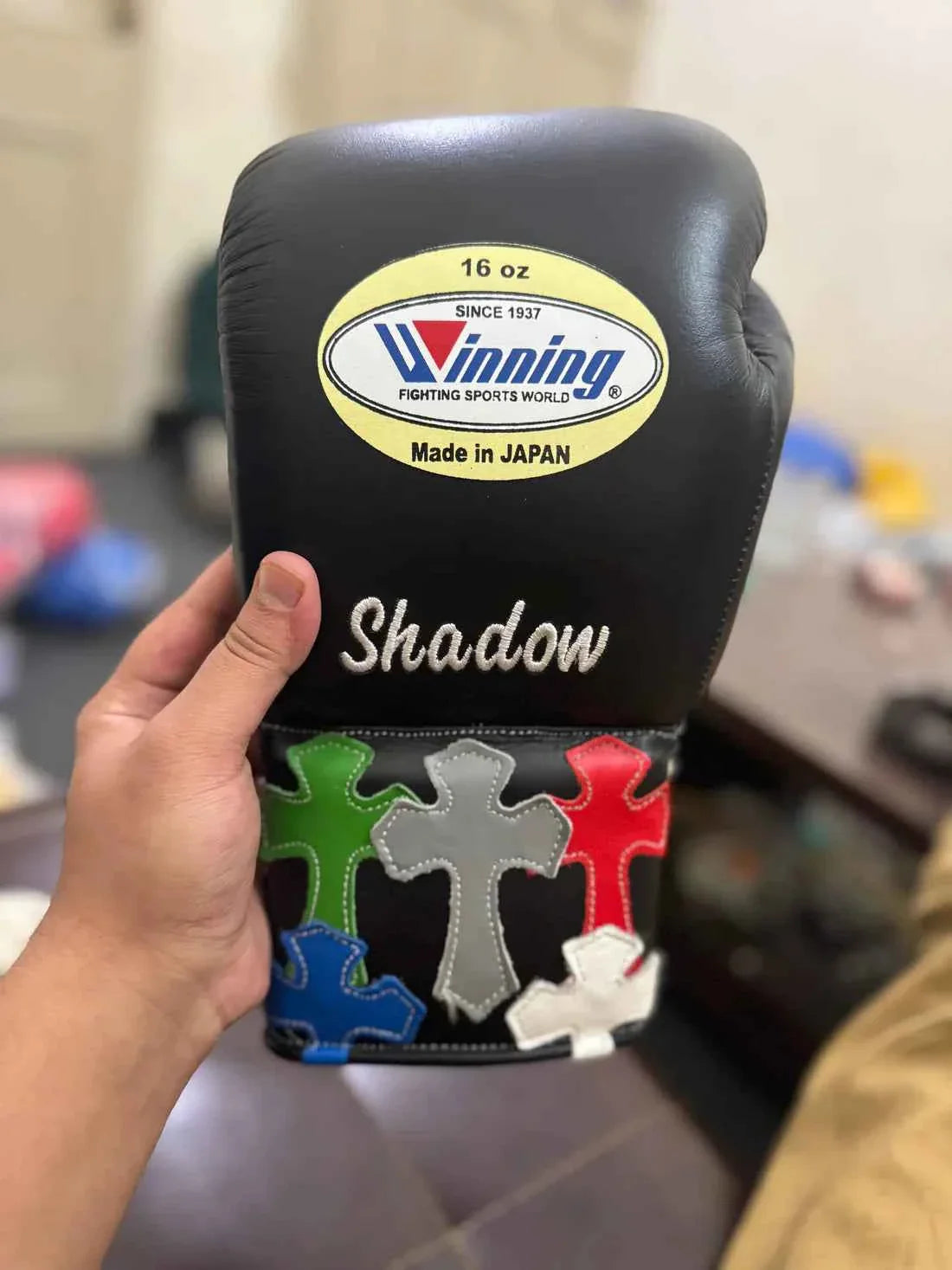 Authentic Black Winning MS-300 professional lace-up boxing gloves with custom "Shadow" text and multi-colored cross patches.