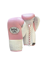 Official No Boxing No Life professional lace-up training boxing gloves in pink leather featuring white cuffs, white lacing panels, a white inner palm track, and the iconic oval brand logo on the knuckles.
