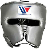 Custom Winning FG-2900 professional boxing headguard in metallic silver leather with official branding and streamlined cheek protectors.