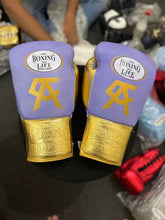 Official No Boxing No Life professional lace-up boxing gloves in premium lavender and metallic gold leather featuring a gold Canelo Alvarez CA logo printed below the brand insignia.