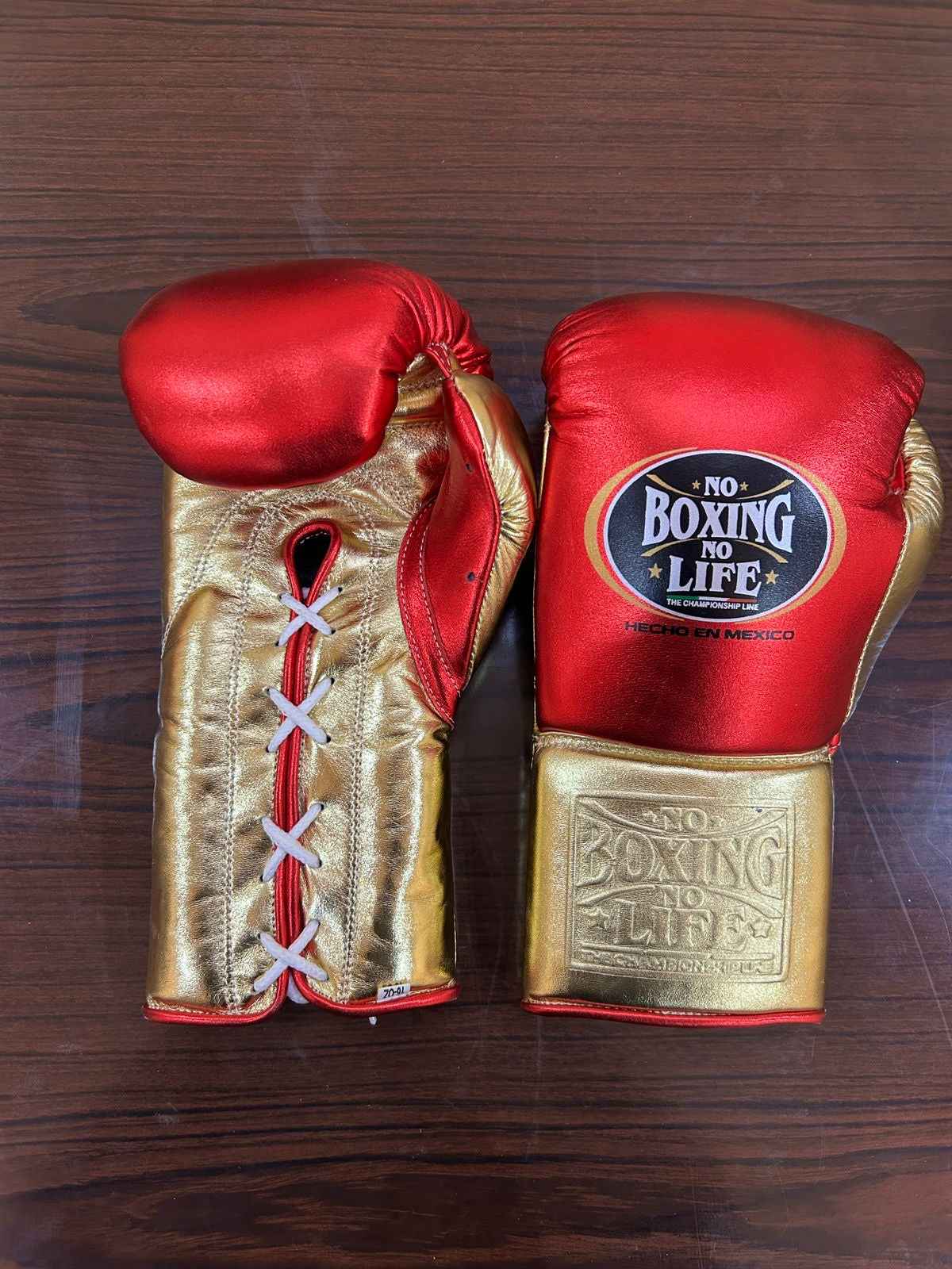 Authentic No Boxing No Life professional boxing gloves in metallic red with metallic gold cuffs and official branding.