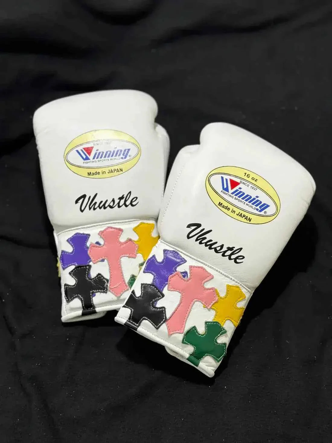 Custom White Winning MS-600 professional lace-up boxing gloves handcrafted in Japan featuring multi-colored cross patches on the cuffs.