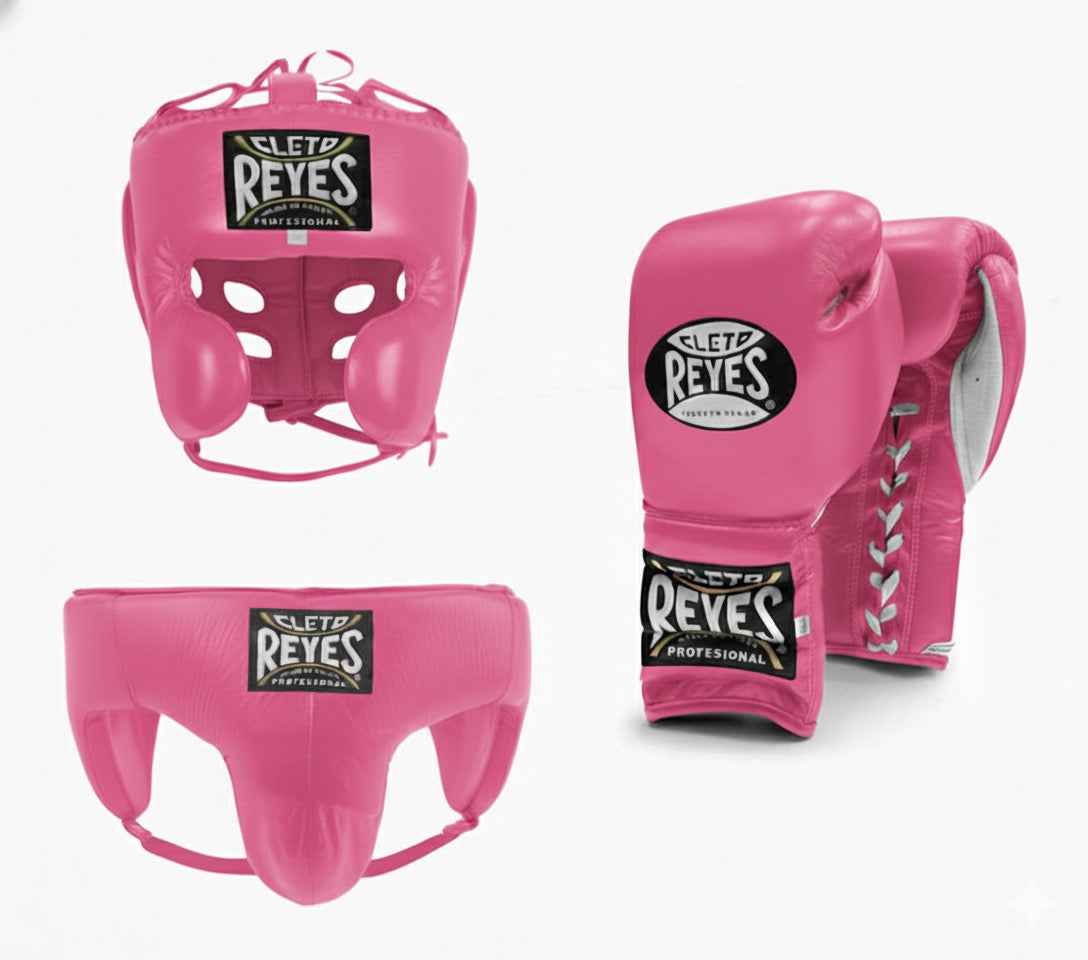 Official Cleto Reyes professional 3-piece boxing sparring gear set featuring matching lace-up gloves, a cheek protector headguard, and a groinguard in uniform vibrant hot pink leather.