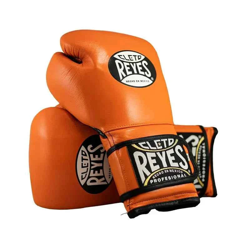 Official Cleto Reyes professional hook-and-loop training boxing gloves in vibrant orange leather featuring a black inner thumb panel, black trim leather piping, and traditional brand patches.