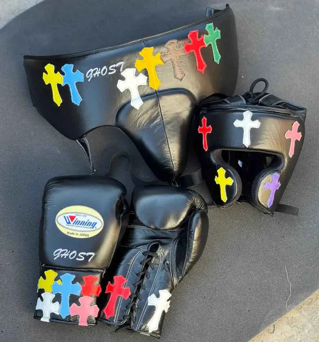 Winning MS-600 Custom Sparring Set in black leather featuring hand-stitched multi-color cross patches on the gloves, headgear, and protector.