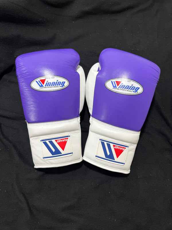 Custom Winning professional lace-up training boxing gloves in a vibrant purple and white leather colorway featuring white laces and the iconic brand logo crest on the cuffs.