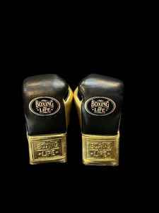 Authentic black and metallic gold No Boxing No Life professional boxing gloves handcrafted in Mexico with official branding.