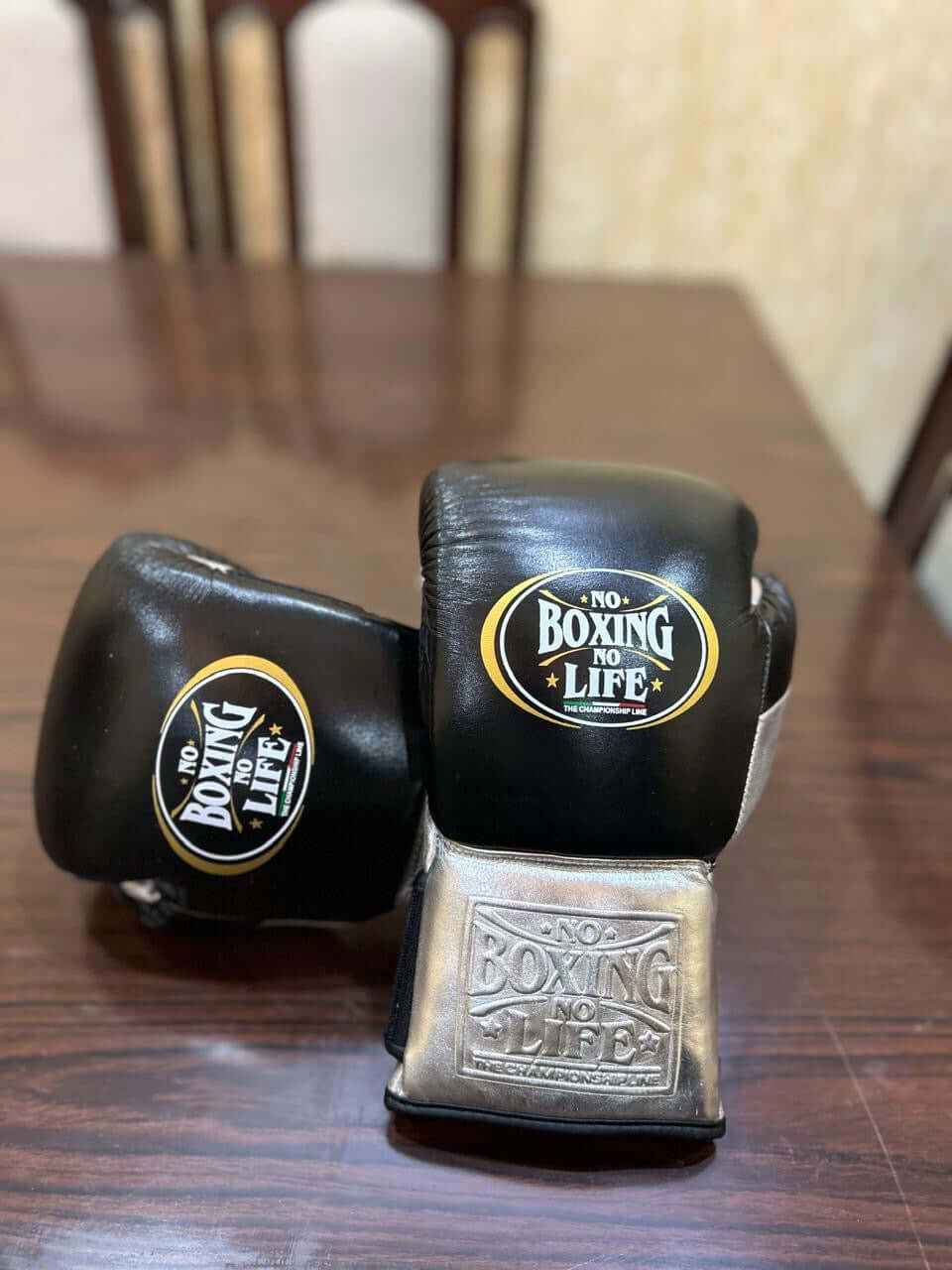 No Boxing No Life professional lace-up boxing gloves in black leather featuring brilliant metallic silver leather cuffs with deep debossed branding and the official crown logos.
