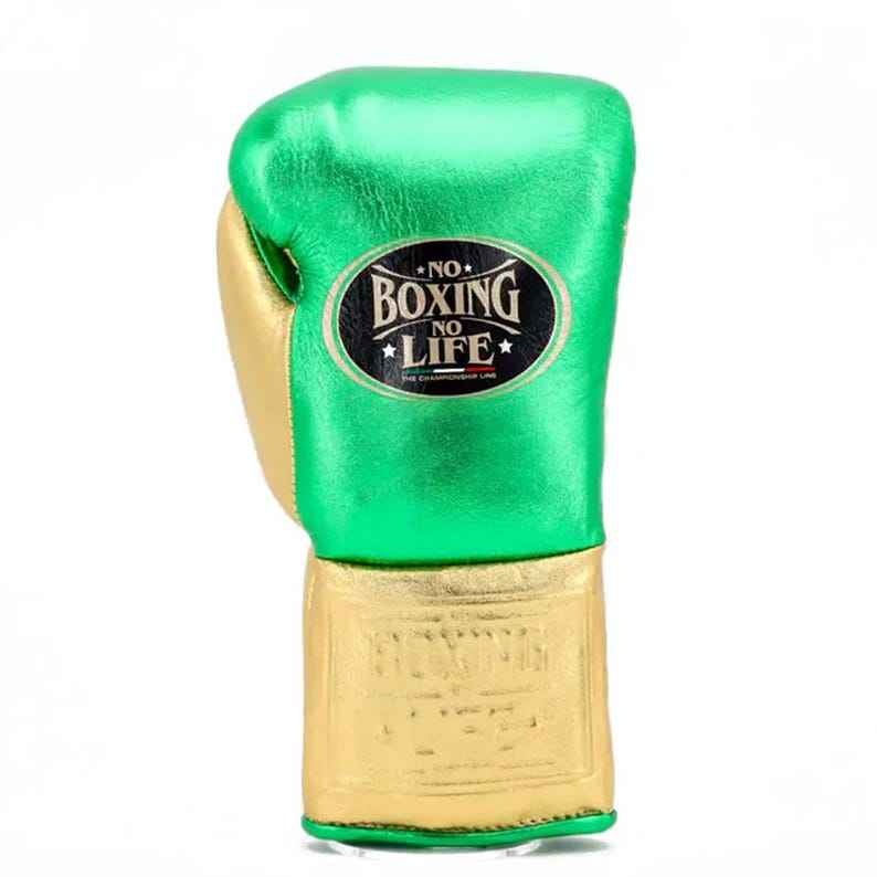 No Boxing No Life professional lace-up boxing gloves in metallic green leather with a metallic gold thumb, palm, and cuff area featuring the official brand patch and contrasting white laces.
