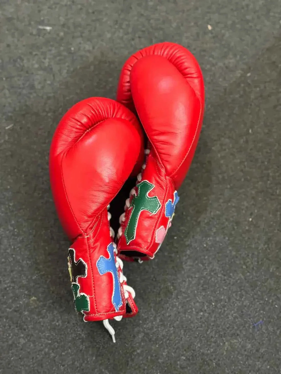 Custom Red Winning MS-300 professional lace-up boxing gloves handcrafted in Japan featuring multi-colored cross patches on the cuffs.