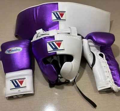 Custom Winning professional 3-piece boxing sparring gear set featuring matching lace-up gloves, a cheek headguard, and a groinguard in an asymmetrical half metallic purple and half pearl white leather colorway.
