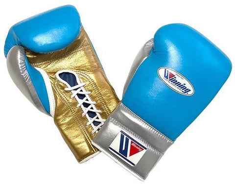 Custom Winning professional lace-up boxing gloves featuring a sky blue leather face, a metallic gold palm, a metallic silver thumb and cuff block, official brand patches, and white laces.