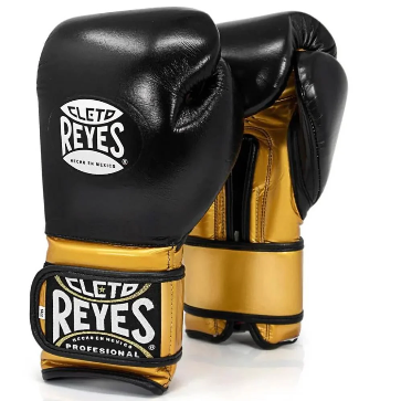 Official Cleto Reyes professional hook-and-loop training boxing gloves featuring a sleek black leather punching face paired with high-sheen gold metallic leather palms, thumbs, and wrist cuffs.