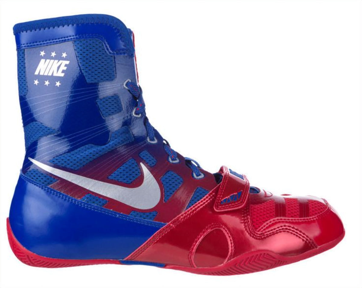 Nike HyperKO 1 boxing shoes in royal blue and university red, side view showing high-top Flywire upper, forefoot strap and metallic white Swoosh