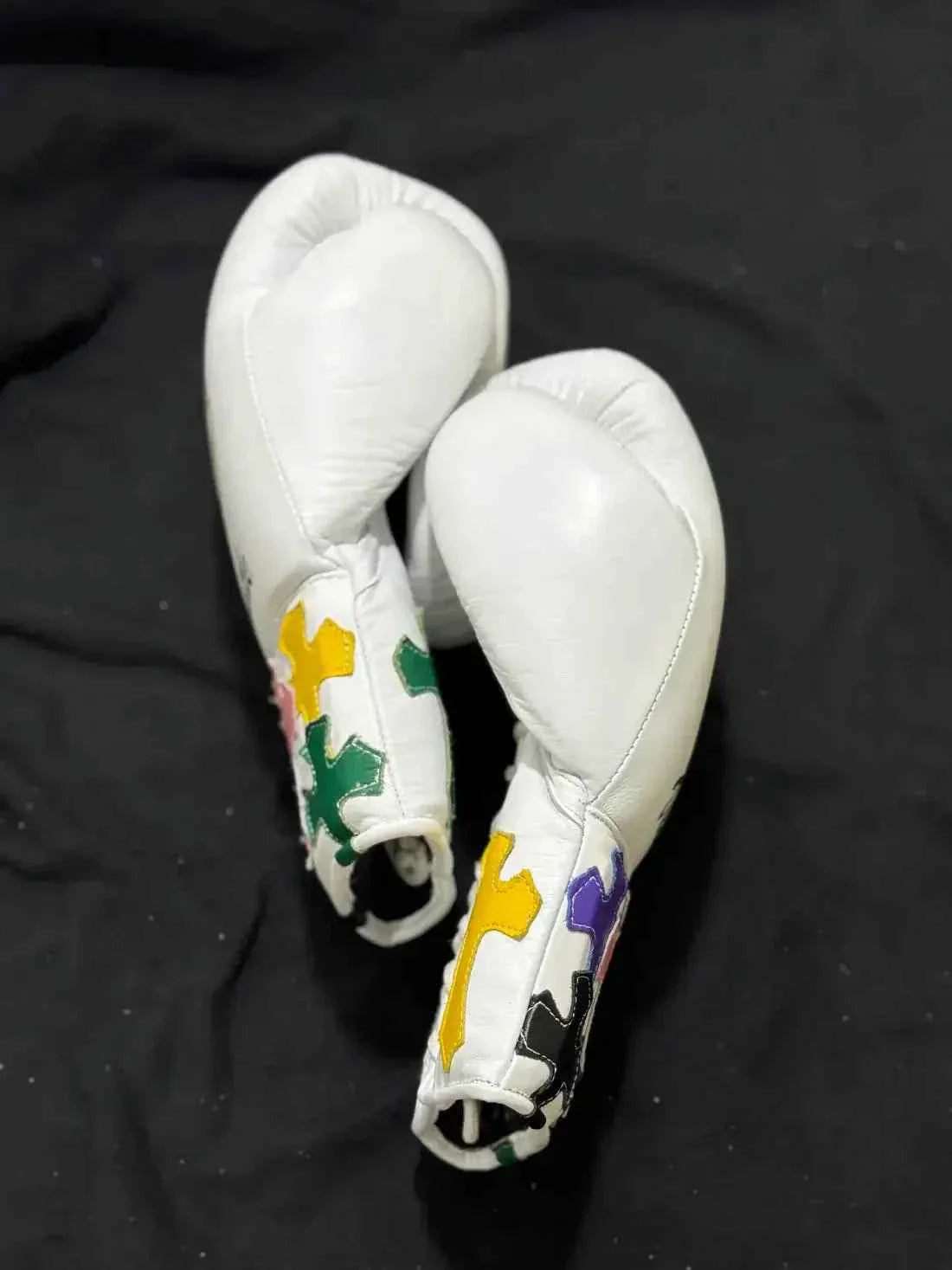Custom White Winning MS-600 professional lace-up boxing gloves handcrafted in Japan featuring multi-colored cross patches on the cuffs.