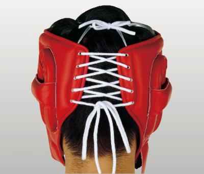 Official Winning FG-2900 professional boxing cheek-protection headgear in classic red leather featuring the iconic brand logo crest patch centered on the forehead.