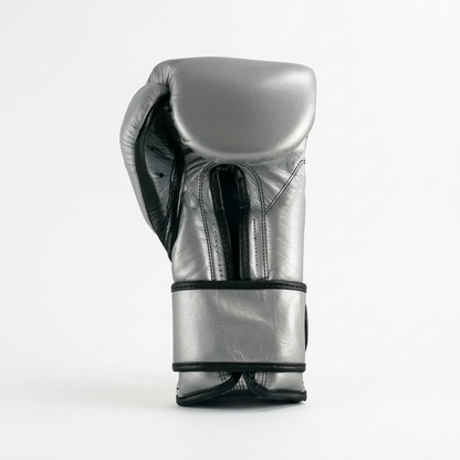 Single Cleto Reyes metallic silver boxing glove with black trim shown from the side