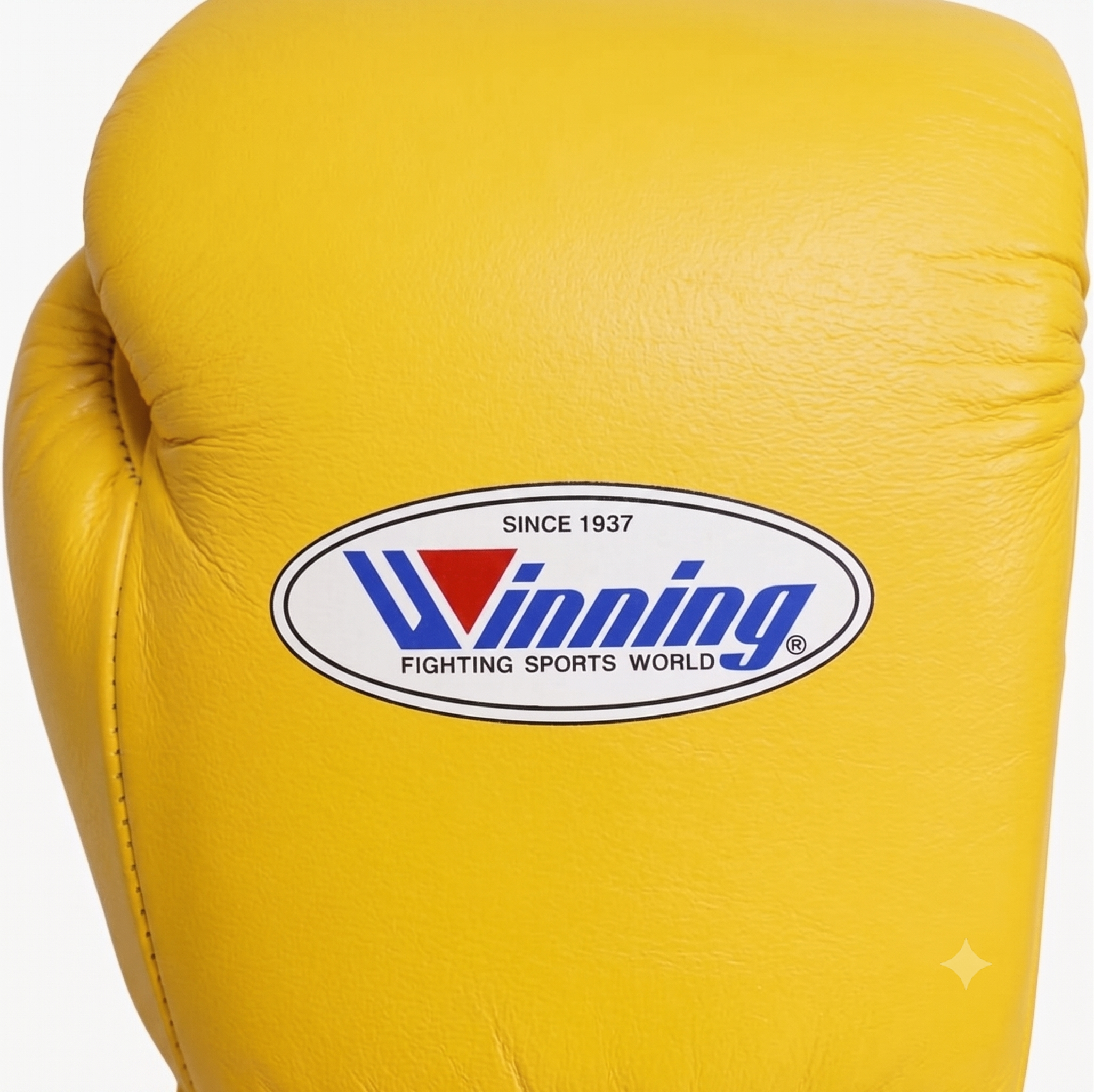 A close-up of a yellow boxing glove featuring the oval Winning Fighting Sports World logo on the front.