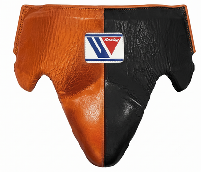 Close-up of Winning orange and black leather boxing headgear showing the brand logo patch