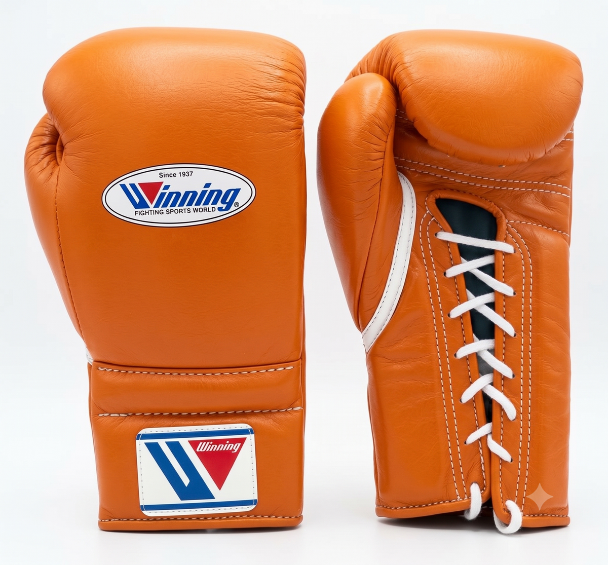 Two orange leather boxing gloves shown on a white background, one displaying the front with a white and blue Winning logo patch, and the other showing the side with white laces.