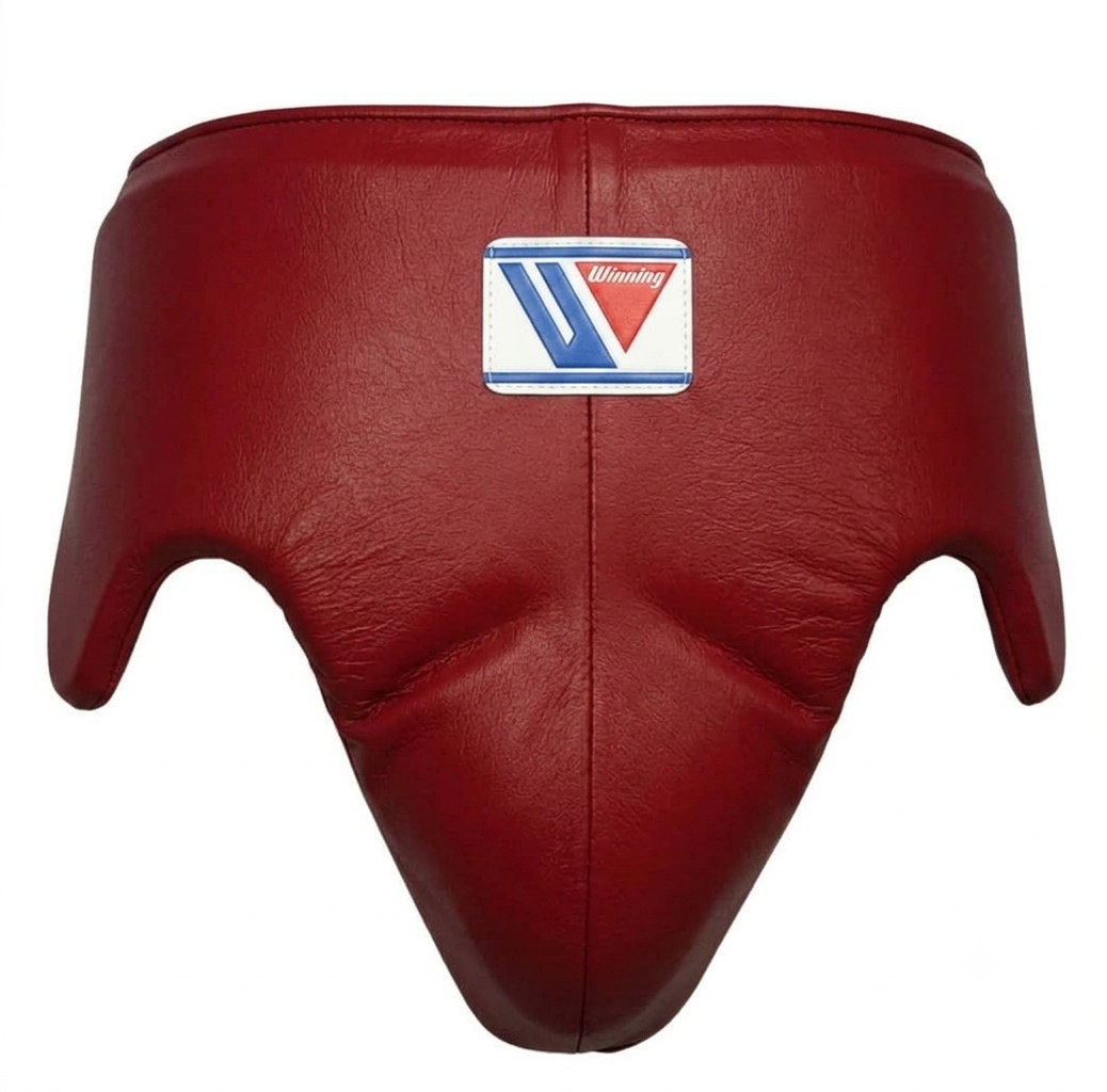 A red leather boxing headguard with a central patch featuring the 'Munty' brand logo, shown against a plain white background.