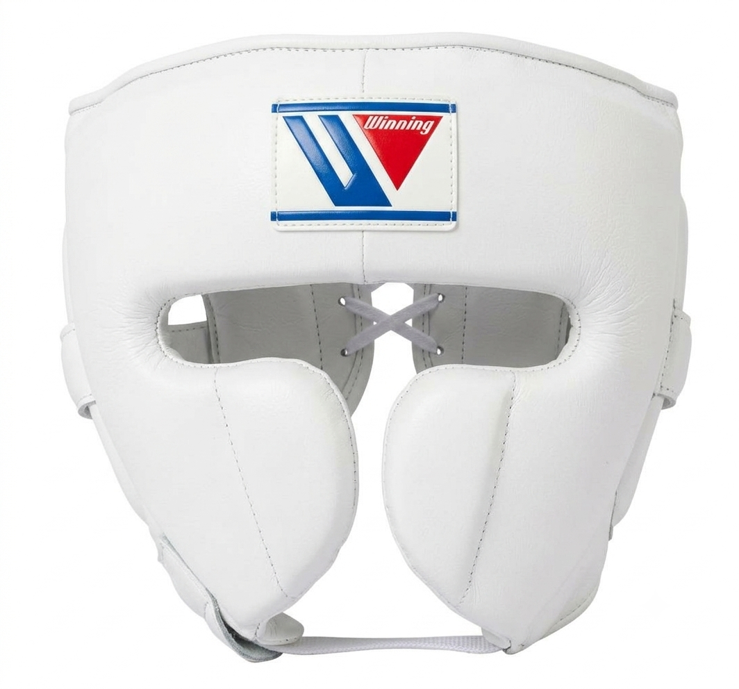 A white leather Winning brand boxing headguard with cheek protection and gray front laces, featuring the classic blue and red Winning logo stitched at the top.