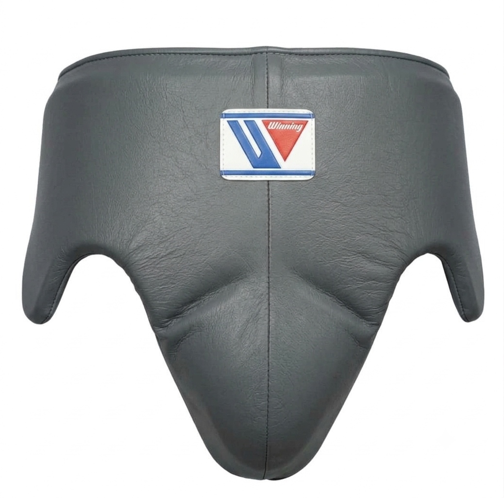Gray leather boxing headgear with a central patch featuring the brand logo, shown against a plain white background.