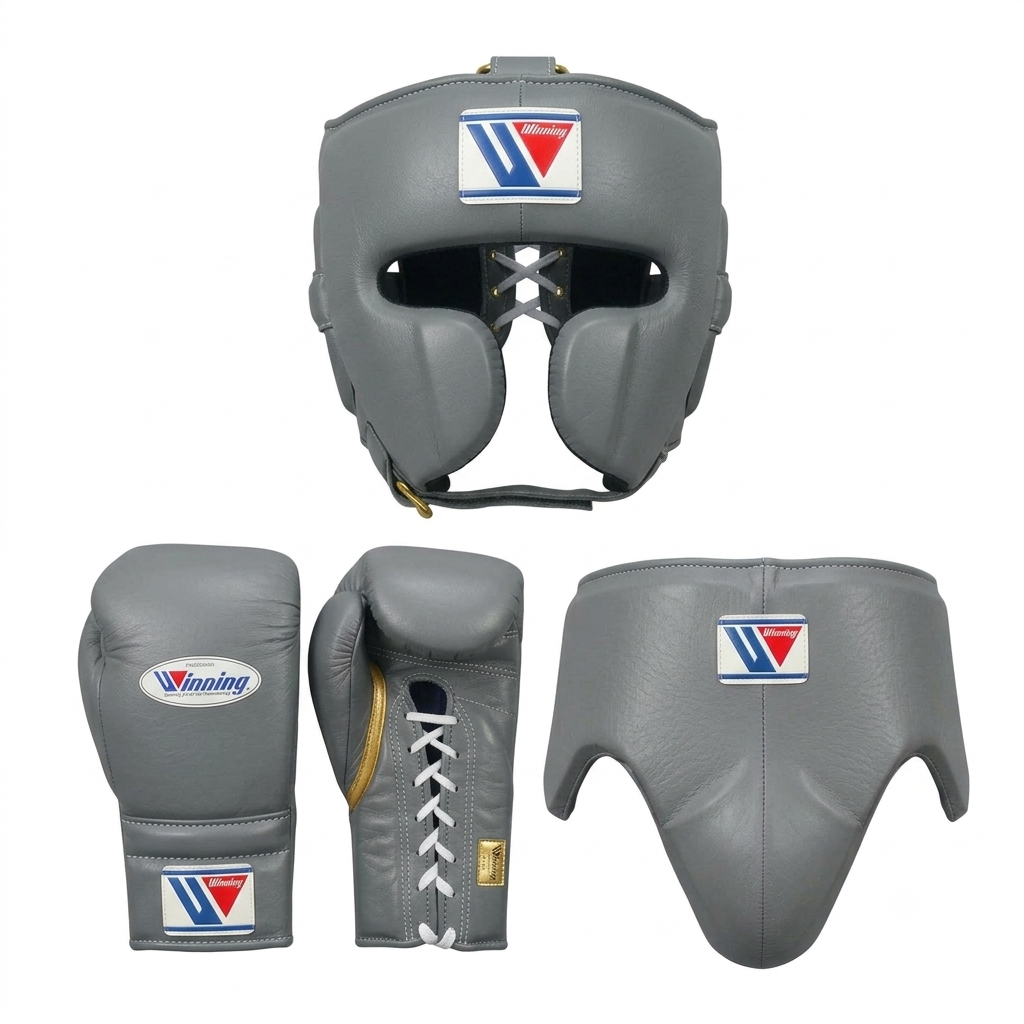Gray boxing gear set including a headguard, gloves, and shin guard, shown from multiple angles on a white background. The set features a prominent 'V' logo with red and blue details on the front of each piece.