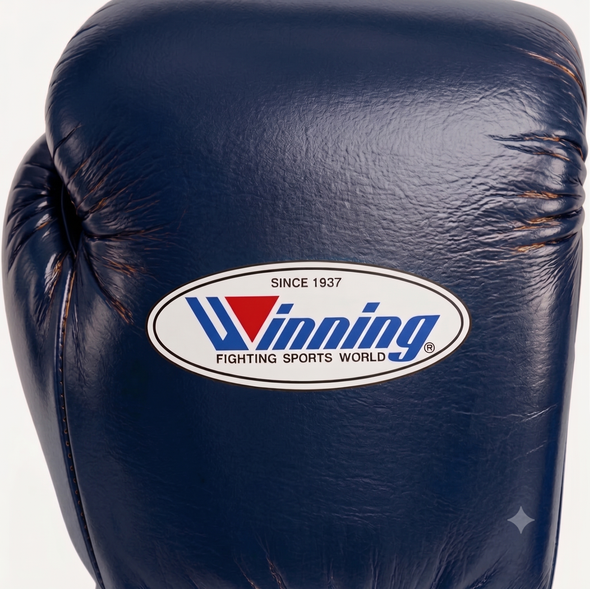 A close-up of a dark navy blue leather boxing glove featuring the oval Winning Fighting Sports World logo on the front.
