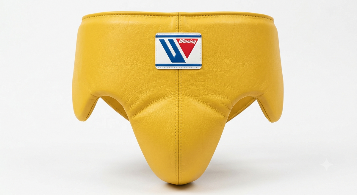 A yellow leather boxing headguard with a central brand patch, photographed against a clean white background.