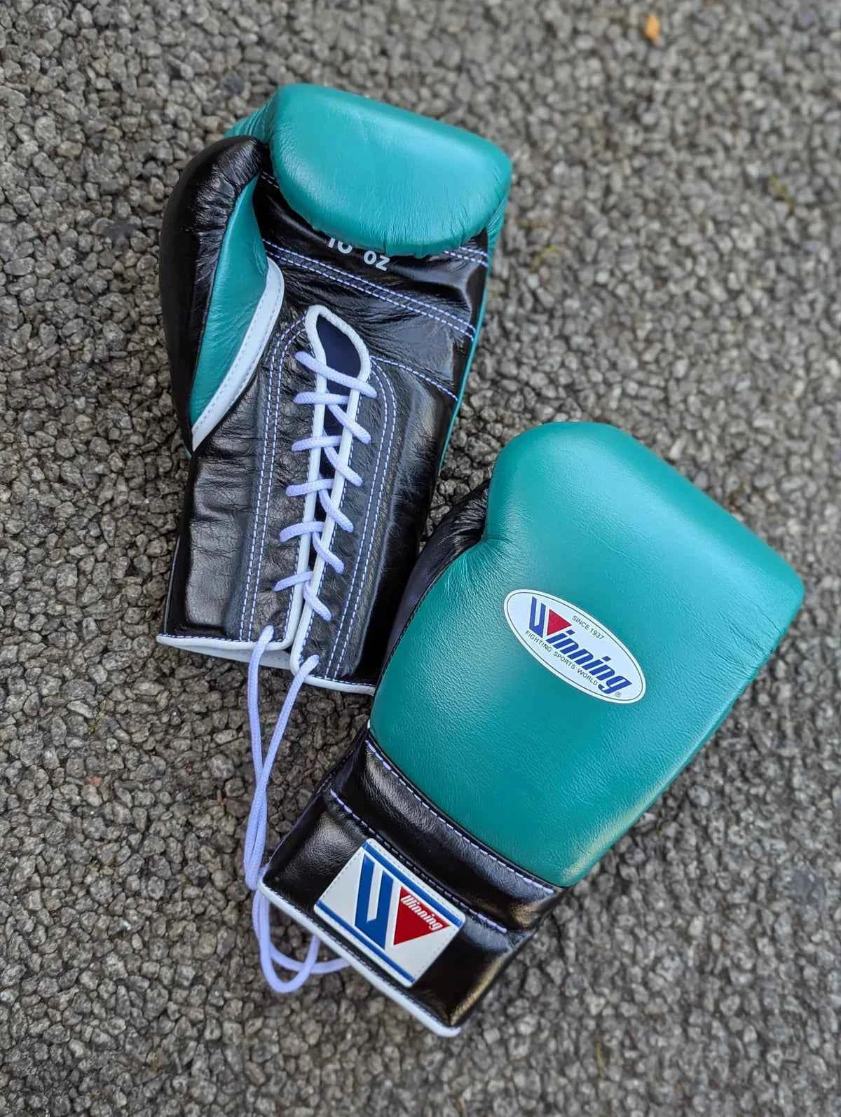 Authentic Winning MS-600-B professional velcro boxing gloves in forest green and black premium leather.