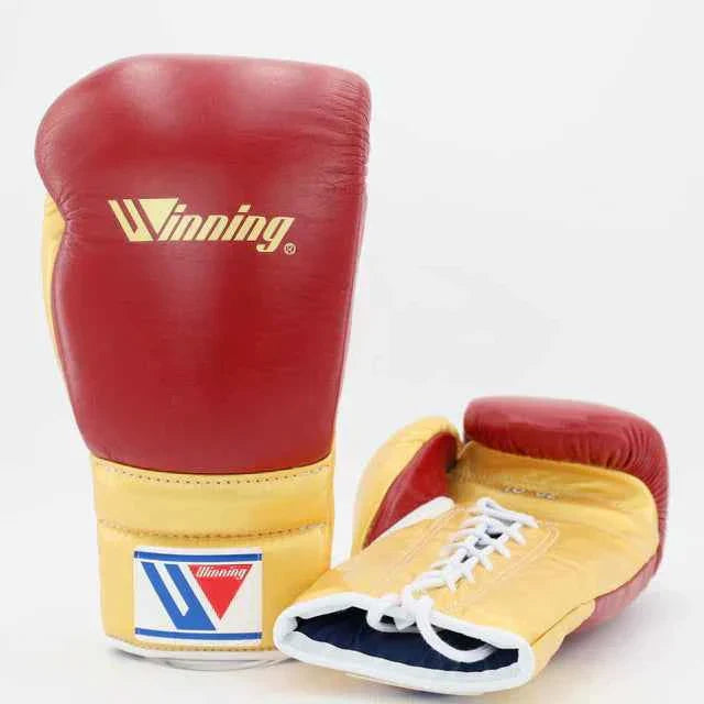 Authentic Winning MS-600 professional lace-up boxing gloves in custom red and metallic gold premium leather.